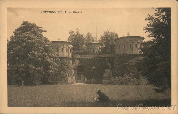 An old fortress surrounded by a public park with a woman reading a book Luxembourg City
