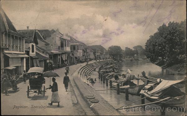 People boating, driving automobiles and walking along a pier Surabaya Indonesia
