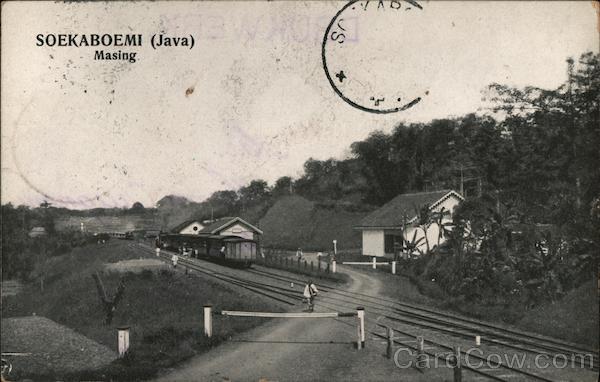 Train station in the Indonesian mountains with pedestrians and cyclists Sukabumi