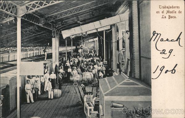 Workers unloading barrels and crates in a wharf Panama City
