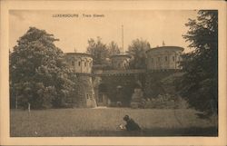 An old fortress surrounded by a public park with a woman reading a book Luxembourg City, Luxembourg Postcard Postcard Postcard