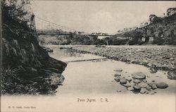 Men on horseback crossing a bridge over a dammed up river Postcard
