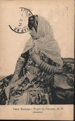 Russian woman wearing a head scarf and a floral striped dress Postcard