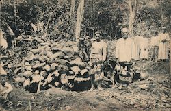 Natives Standing by a Pile of Rocks Postcard