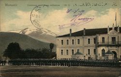 Military cadets lined up outside a school with a mountain in the distance Postcard