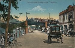 Train bridge crossing over a street with automobiles and horse carts Postcard