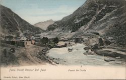 Train bridge crossing a river between the mountains Postcard