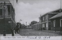 Cobblestone street lined with two-story buildings, utility poles with pedestrians Postcard