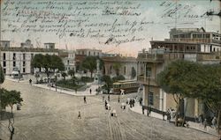 Wide boulevard and city square with pedestrians and a street car Postcard