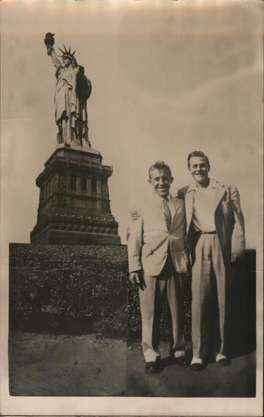 Two Men Standing in Front of the Statue of Liberty New York City