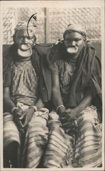 Women Pose with Lip Plates Postcard