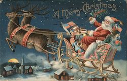 A Merry Christmas - Santa Driving his Sleigh over a Town with 2 Reindeer Pulling it Postcard