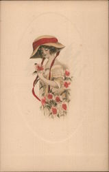 A little girl with a large hat looking at pink flowers Postcard