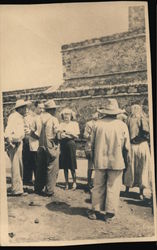 Group of men and women standing beside old stone building Original Photograph