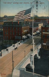 "Old Glory" Waving over Aurora, Ill. City of Lights Postcard