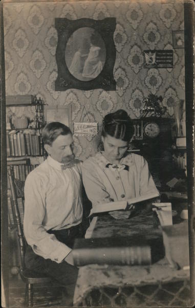Couple Reading at Table Women