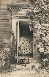 Front porch with a rocking chair Postcard