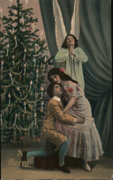 A Man and Woman Hugging in Front of a Christmas Tree and an Angel