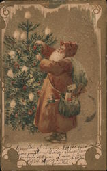 Santa hanging ornaments on the tree Postcard