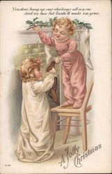 Two Children Getting Their Stocking Off the Mantel Postcard