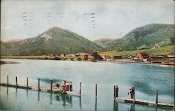 Palmer Lake dock with people fishing and town in view across the lake Postcard