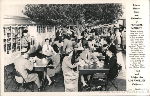 Tables under trees and umbrellas at Farmers Market Third and Fairfax Ave Los Angeles California