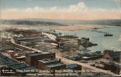 View from the 42 story L.C. Smith Building showing the rapidly growing railroad and shipping interests of Seattle Postcard