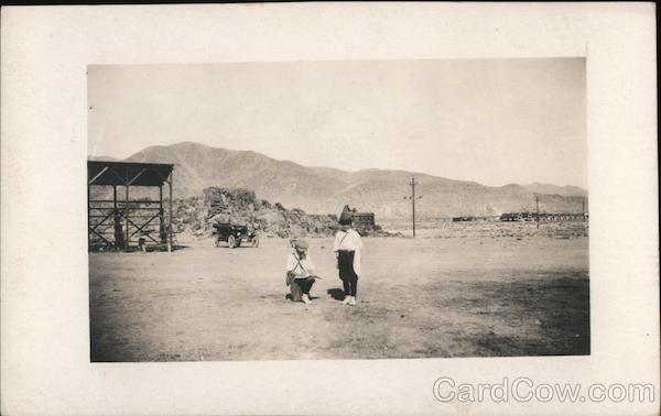 Two young boys in dust area Children