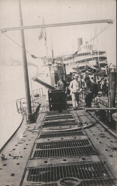 Men on docked WWI-era Submarine Ships