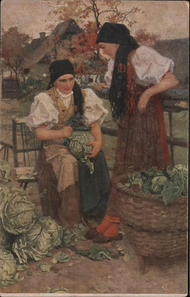 Two farm worker women cleaning cabbages