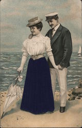 Man and Woman on the beach by the Sea Postcard