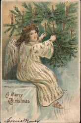 A Merry Christmas - Angel lighting candles on tree Postcard