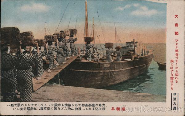 Women carrying bales of firewood onto boat Oshima Japan