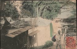 Japanese man walking through village Postcard