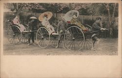 Japanese women riding in a rickshaw Postcard