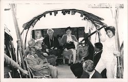 Tourist group on boat being poled by girl, bamboo seating. Postcard