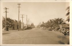 Main street view, vintage cars, electrical poles, street light, palm trees Postcard
