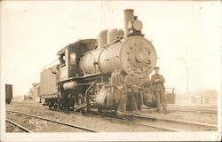 Three Men Sitting on the Front of a Steam Engine Postcard