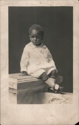 Black toddler posed on column, studio portrait Postcard