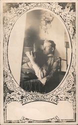 An old photo of a man reading. Postcard