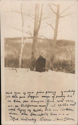 Man in waist high snow near trees Postcard