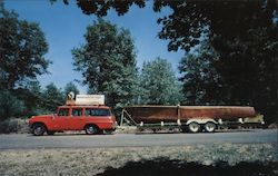 Redwood Indian Dugout Boat on trailer, pulled by car. Postcard