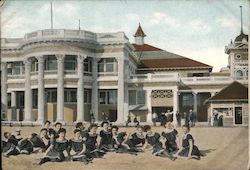 Taking a Sun Bath in Front of a Long Beach Bath House Postcard