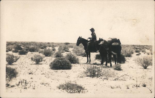 Man on horse with loaded burro in dessert Palm Springs California