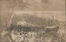Couple in a canoe on a lake Postcard