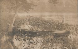 Couple in a canoe on a lake Canoes & Rowboats Postcard Postcard Postcard