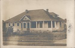 House with wood siding and a porch Postcard