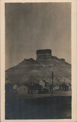 Houses at the base of a mesa California? Nevada? New Mexico? Postcard