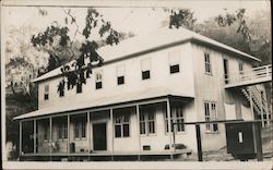 Large two story wood frame building Postcard