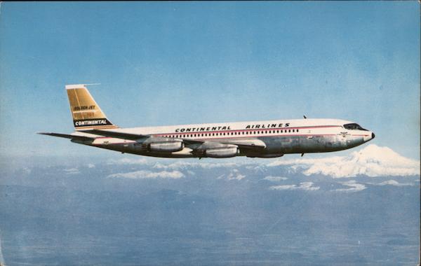 Continental Airlines Golden Jet Boeing 707 flying over Mt. Rainier, Washington